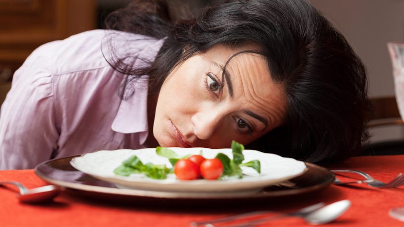 Woman looking to a little salad is tired about diet.; Shutterstock ID 209306980; PO: today.com gabrielle-health